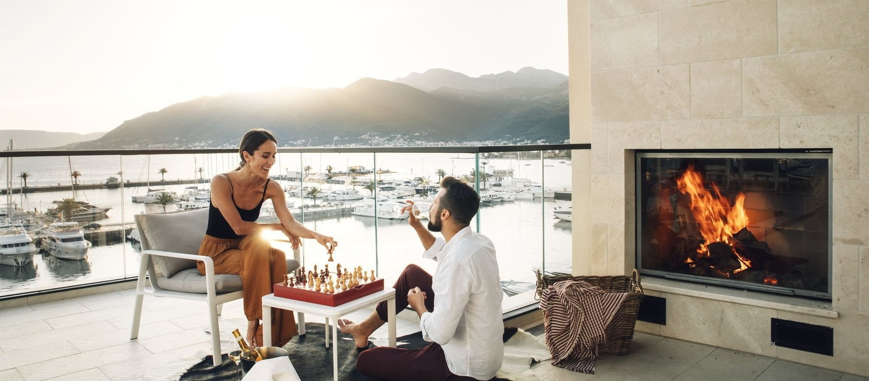 Couple playing chess on balcony in Porto Montenegro residence