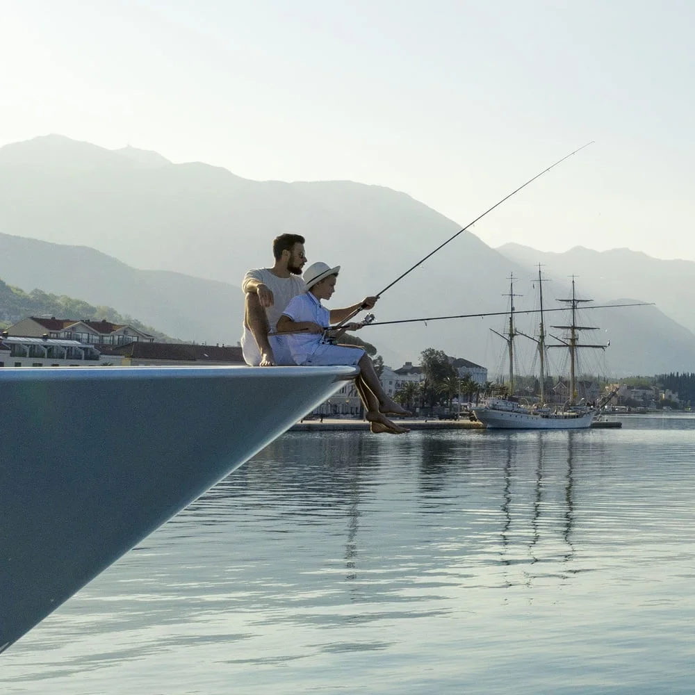 Father and son fishing on yacht Montenegro
