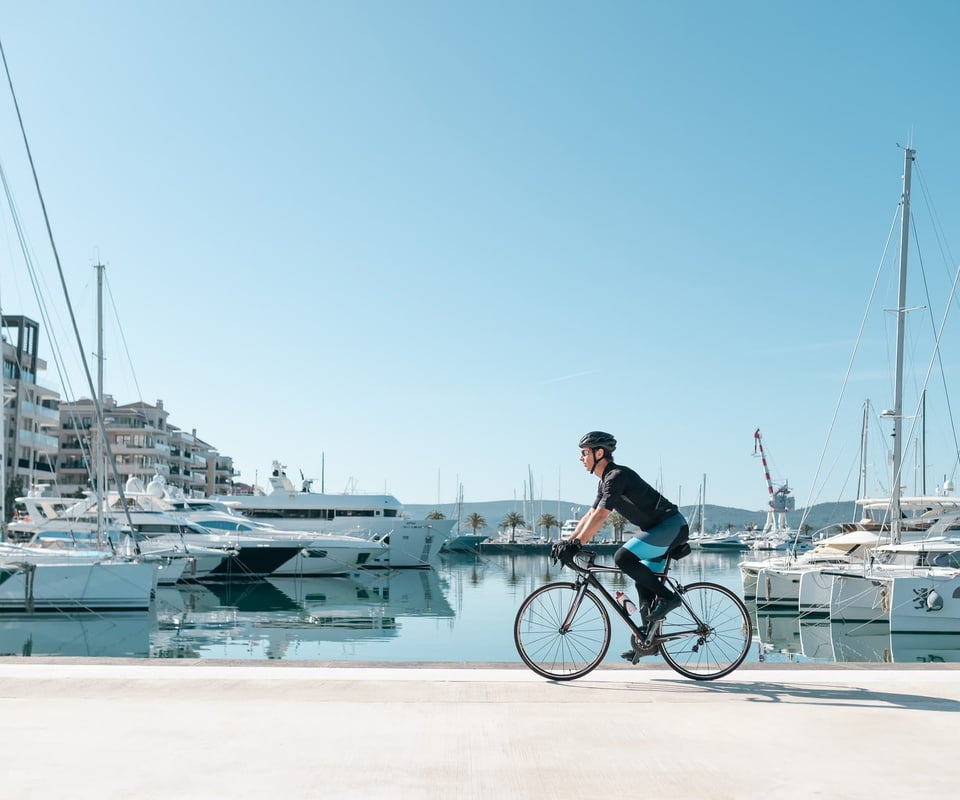 Man cycling along marina porto montenegro