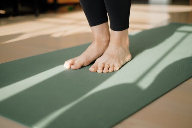 Woman performing on a Pilates matt