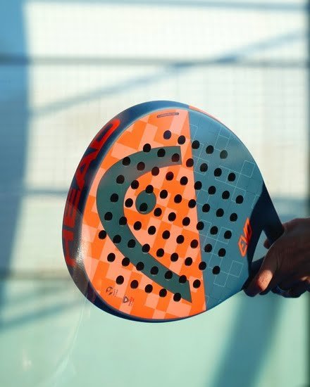 Person holding a padel racket