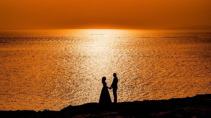 couple at the sea with sunset