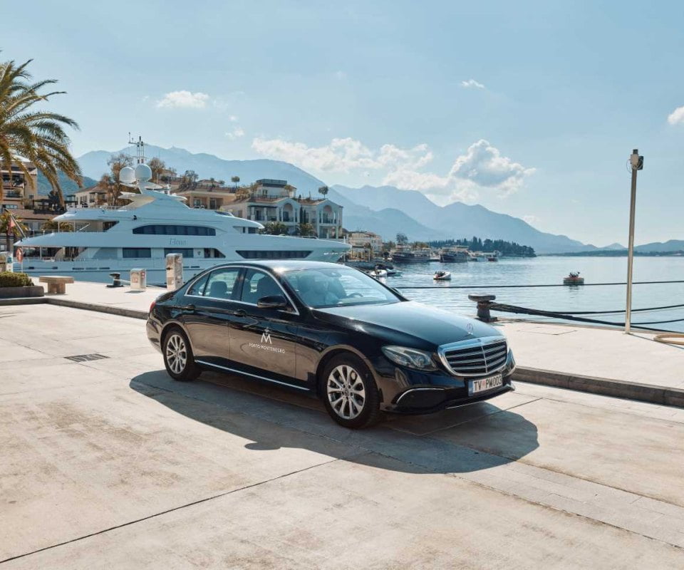 Car with yacht in background