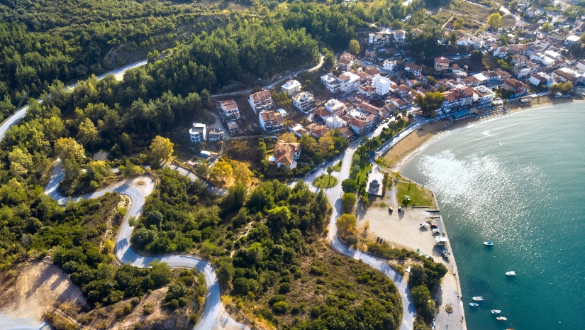 Aerial drone view of blue sea and houses.