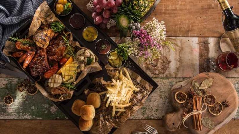 Traditional local food arranged on a rustic wooden table.