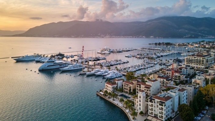 Aerial view of Porto Montenegro marina with luxury residences and boats docked.