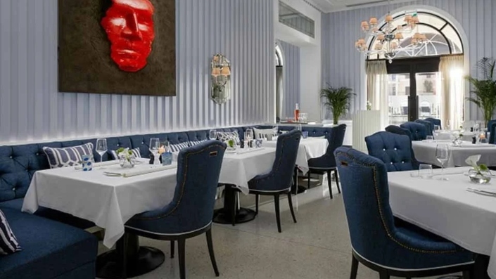 Elegant interior of Murano restaurant in Porto Montenegro, featuring white tablecloths, stylish decor, and a refined dining atmosphere.