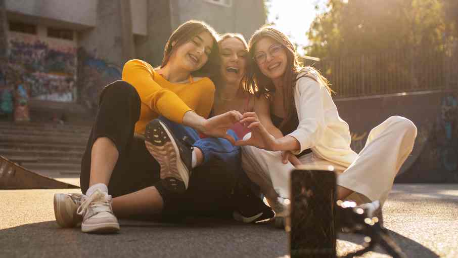 Three Generation Z teenagers pose for a photo, illustrating the digital native lifestyle and youth engagement.