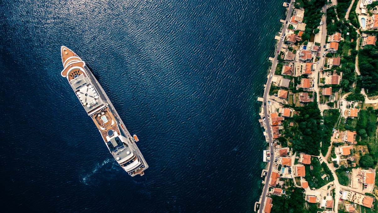 Aerial view of a luxury yacht sailing along Montenegro’s Adriatic coast.