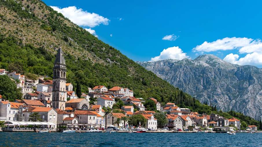 Waterfront view of Perast with historic stone buildings and bay.