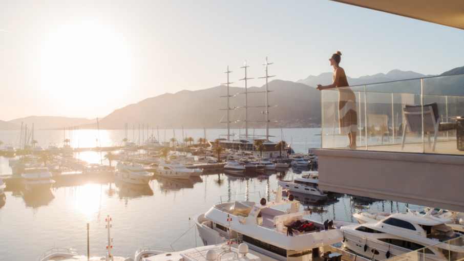 Luxury yachts and waterfront promenade at Porto Montenegro marina.