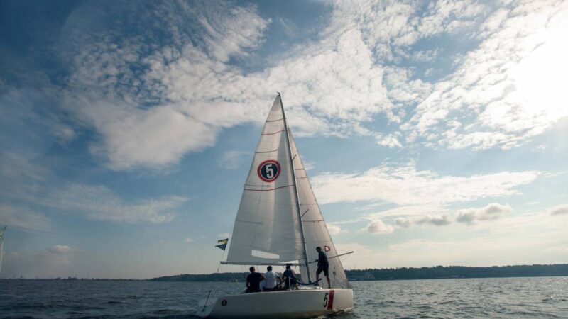 Sailing yachts racing across open blue water.